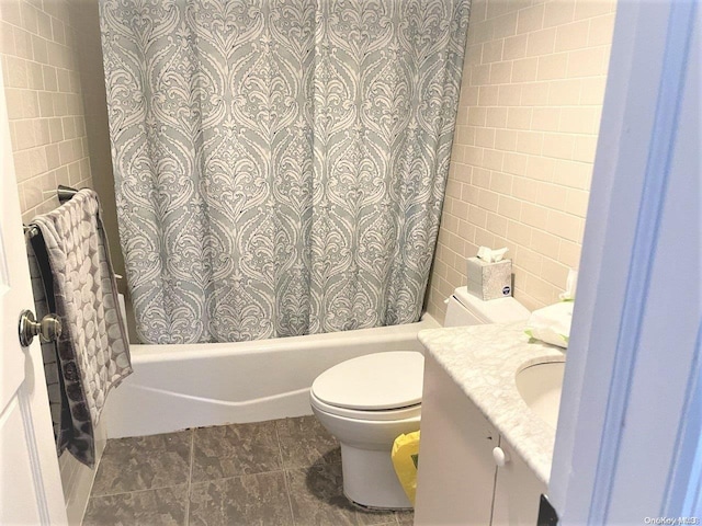 full bathroom featuring vanity, shower / bath combination with curtain, tile patterned flooring, toilet, and tile walls