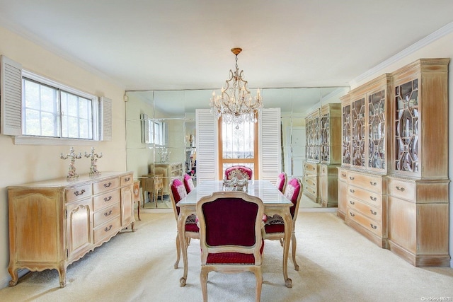 carpeted dining space with ornamental molding and an inviting chandelier