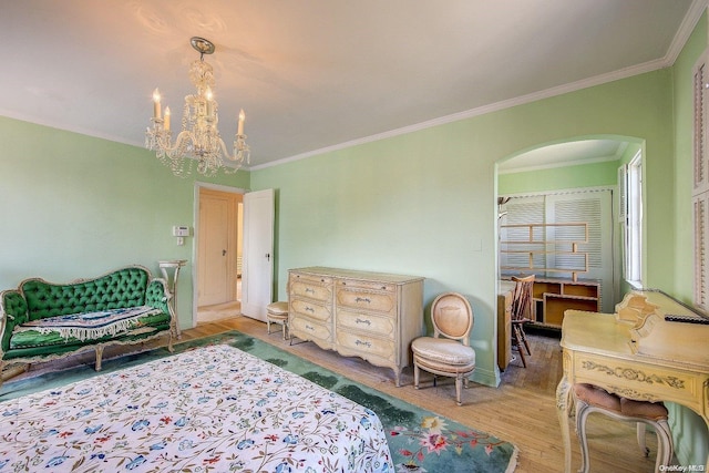 bedroom with wood-type flooring, crown molding, and a chandelier