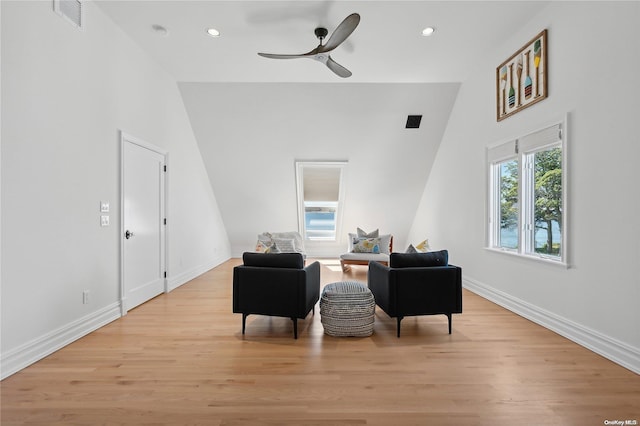 sitting room featuring high vaulted ceiling, light hardwood / wood-style flooring, and ceiling fan