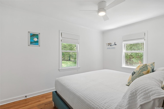 bedroom featuring hardwood / wood-style floors and ceiling fan