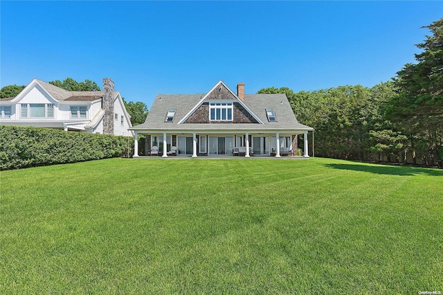 view of front of house with a porch and a front yard