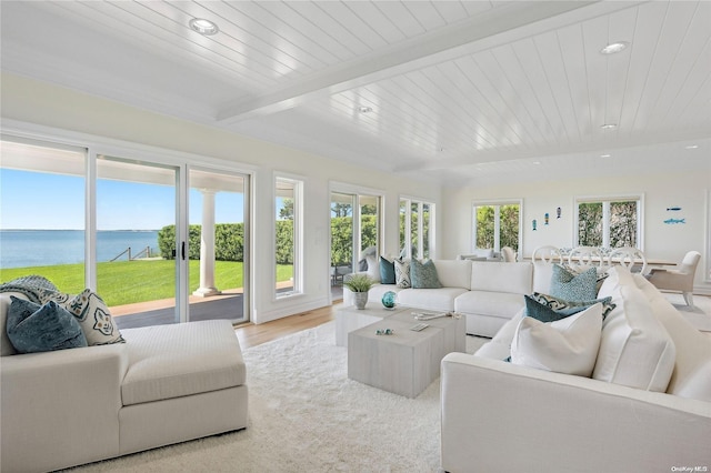 sunroom / solarium with a wealth of natural light, beamed ceiling, a water view, and wood ceiling