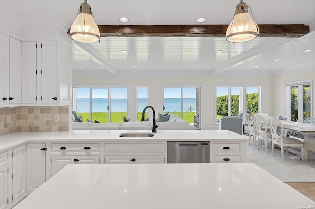 kitchen with a water view, sink, stainless steel dishwasher, light wood-type flooring, and beamed ceiling