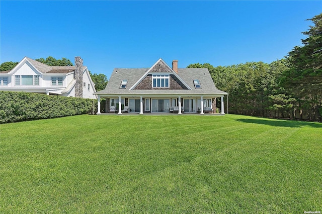 2100 Park Ave, Mattituck, NY 11952 - view of front of house featuring a front lawn, a chimney, and a porch