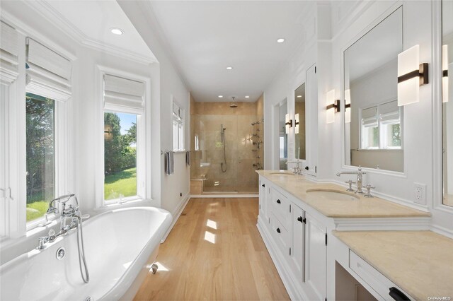 2100 Park Ave, Mattituck, NY 11952 - bathroom featuring a stall shower, a soaking tub, wood finished floors, double vanity, and recessed lighting