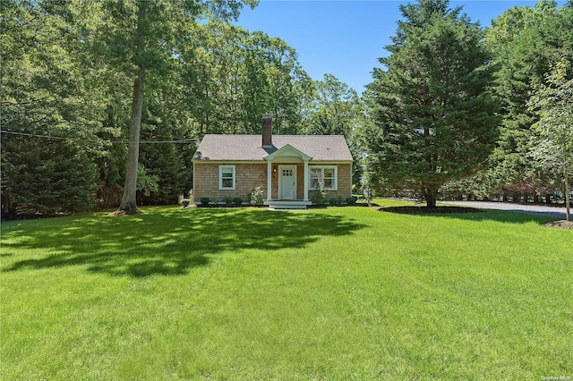 2100 Park Ave, Mattituck, NY 11952 - view of front of house with a front yard and a chimney