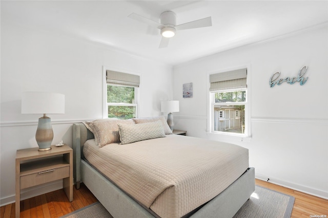 2100 Park Ave, Mattituck, NY 11952 - bedroom with multiple windows, wood finished floors, and ceiling fan
