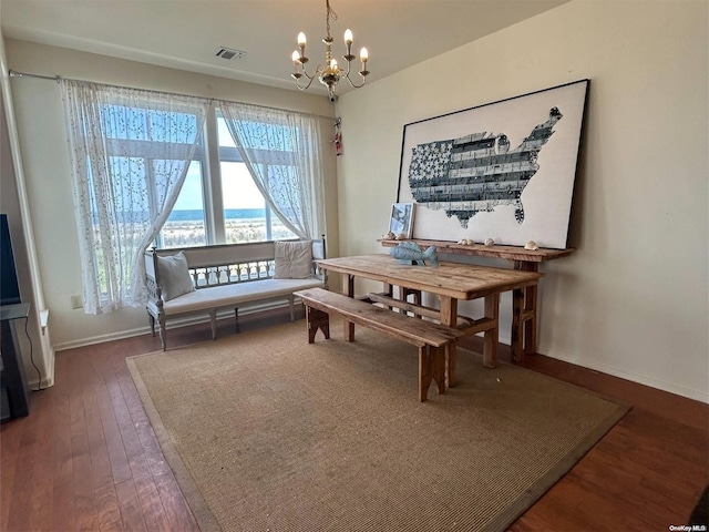 dining area with a chandelier and dark wood-type flooring