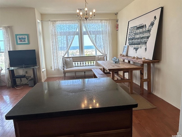 dining area with hardwood / wood-style floors and a notable chandelier