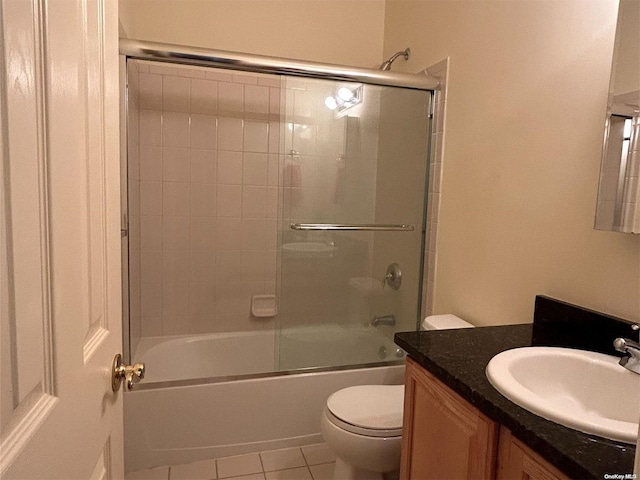 full bathroom with tile patterned flooring, vanity, toilet, and enclosed tub / shower combo