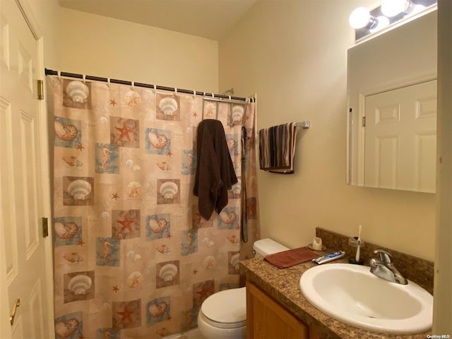 bathroom featuring a shower with curtain, vanity, and toilet