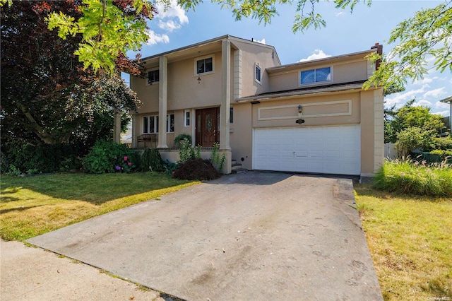 view of front facade with a garage and a front lawn