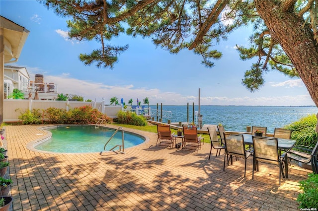 view of swimming pool with a water view, a patio, and a boat dock