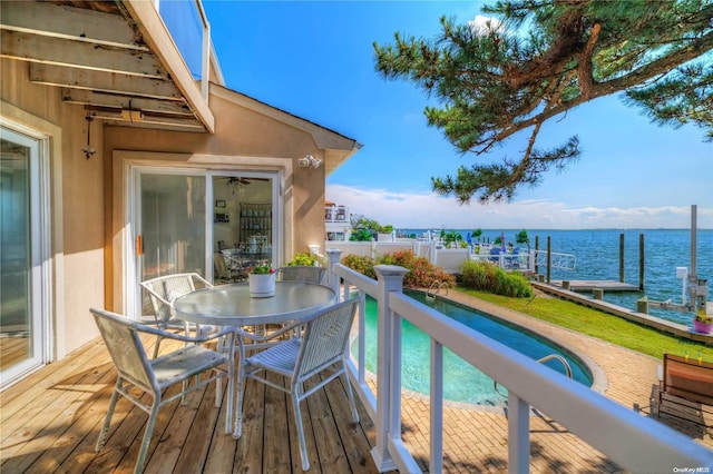 balcony with a boat dock and a water view