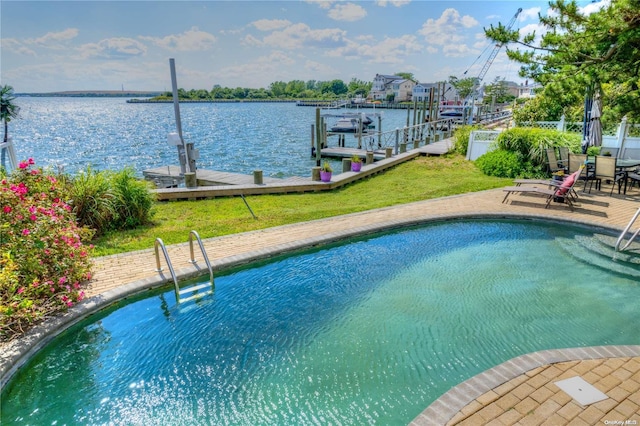 view of pool featuring a dock, a patio area, and a water view