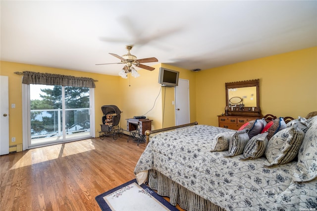 bedroom with ceiling fan, access to exterior, wood-type flooring, and baseboard heating