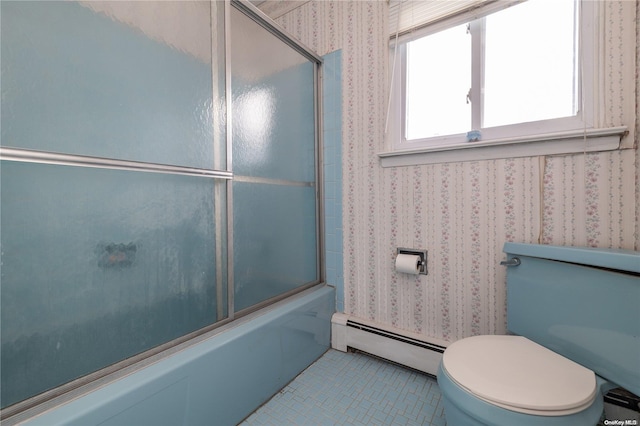 bathroom featuring tile patterned floors, combined bath / shower with glass door, toilet, and a baseboard radiator