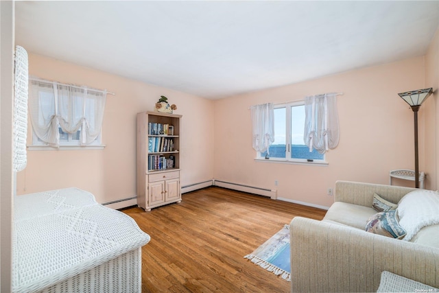 interior space with light wood-type flooring and baseboard heating