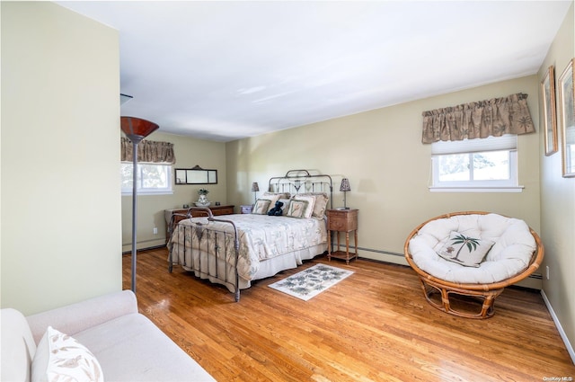 bedroom featuring hardwood / wood-style floors and baseboard heating