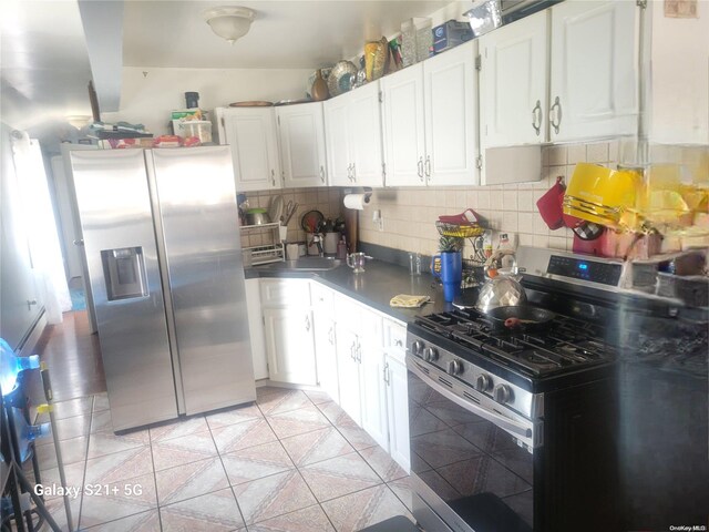 kitchen featuring white cabinetry, backsplash, and appliances with stainless steel finishes