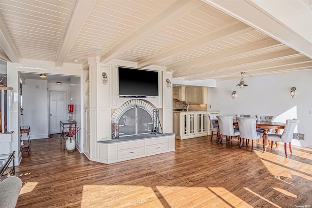 living room featuring beam ceiling and wood-type flooring