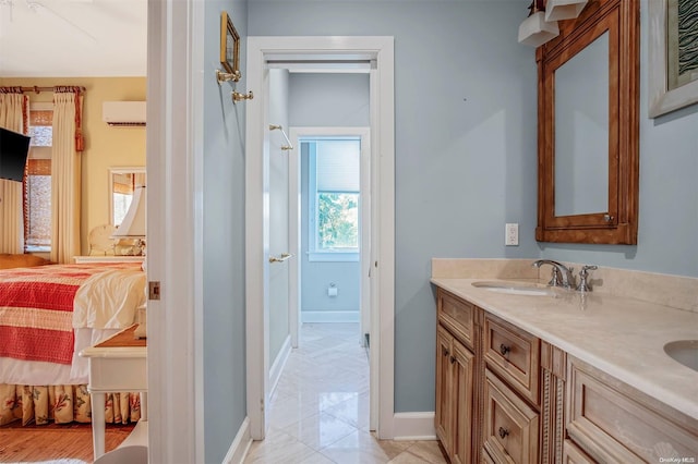 bathroom with a wall unit AC and vanity