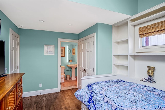 bedroom featuring dark hardwood / wood-style flooring and connected bathroom