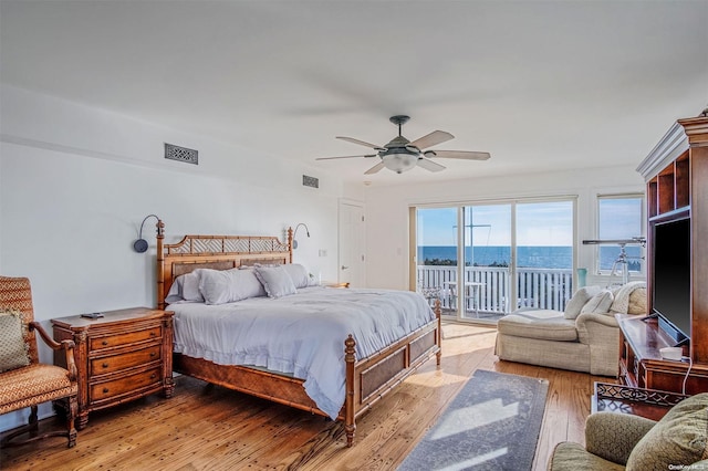 bedroom with ceiling fan, light hardwood / wood-style floors, and access to exterior