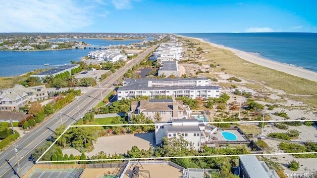 aerial view with a water view and a view of the beach