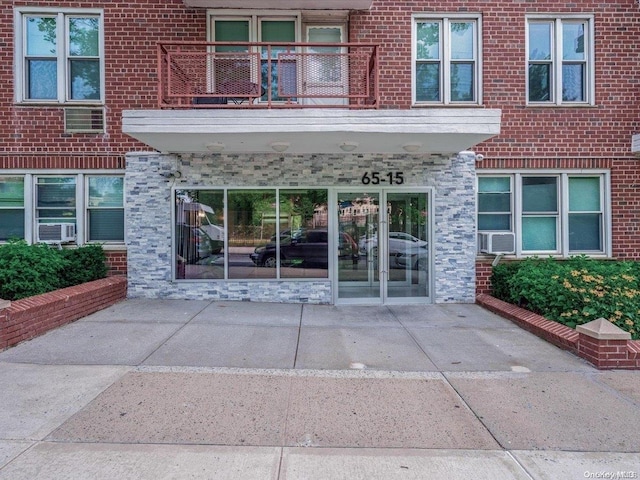 doorway to property with a balcony and a patio area