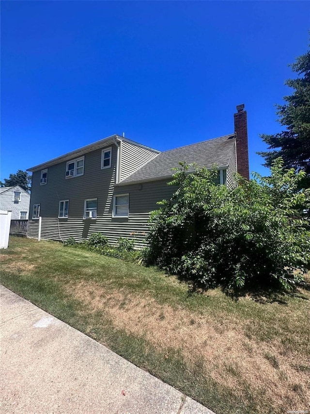 view of side of home featuring a lawn