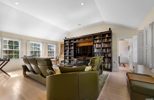 living room featuring vaulted ceiling and light wood-type flooring