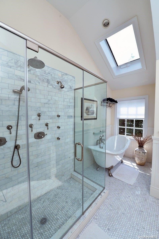 bathroom featuring tile patterned flooring, lofted ceiling with skylight, and independent shower and bath