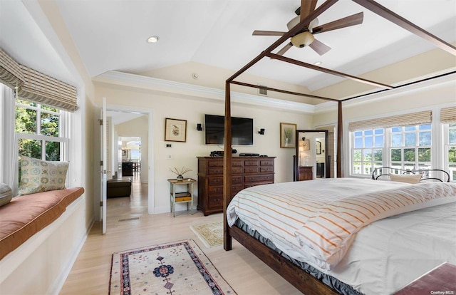 bedroom with ceiling fan, crown molding, lofted ceiling, and light wood-type flooring