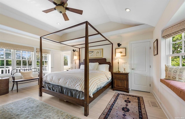 bedroom with ceiling fan, light hardwood / wood-style flooring, and vaulted ceiling