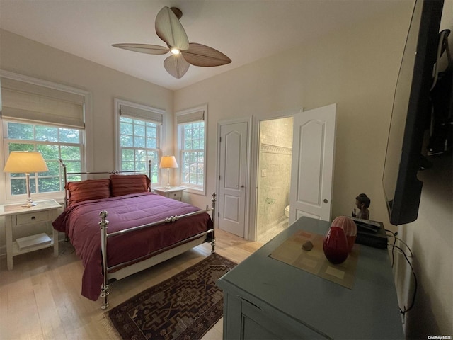 bedroom with ceiling fan, light hardwood / wood-style floors, and connected bathroom