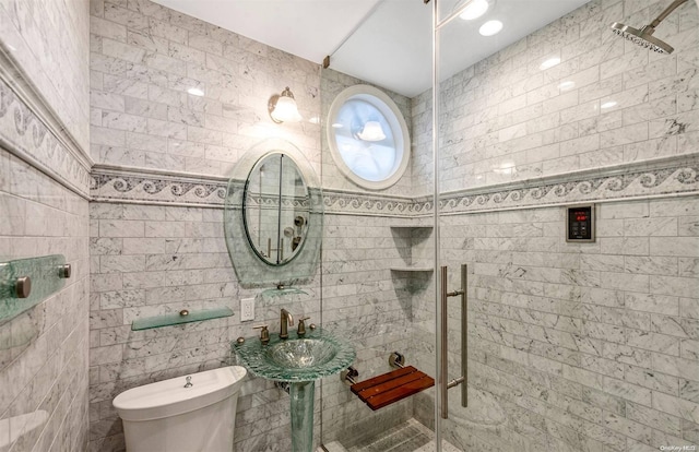 bathroom with a tile shower, tile walls, and toilet