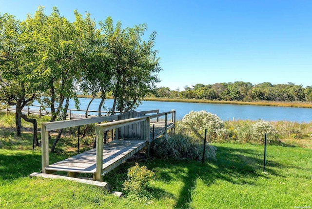 dock area featuring a yard and a water view