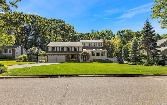 view of front of house featuring a front lawn and a garage