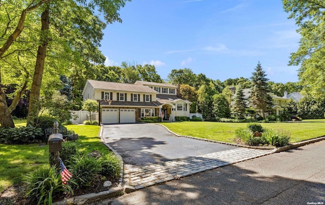 view of front of property with a front yard and a garage