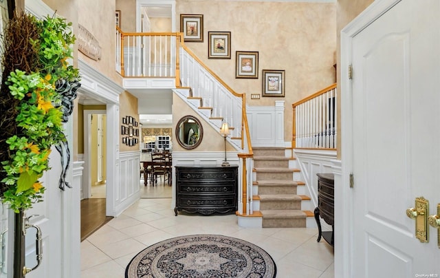 tiled foyer with a high ceiling