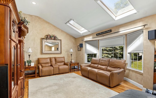 living room featuring vaulted ceiling with skylight, a baseboard radiator, and light hardwood / wood-style flooring