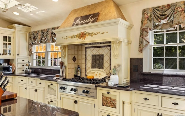 kitchen featuring decorative backsplash, stainless steel gas cooktop, and cream cabinets