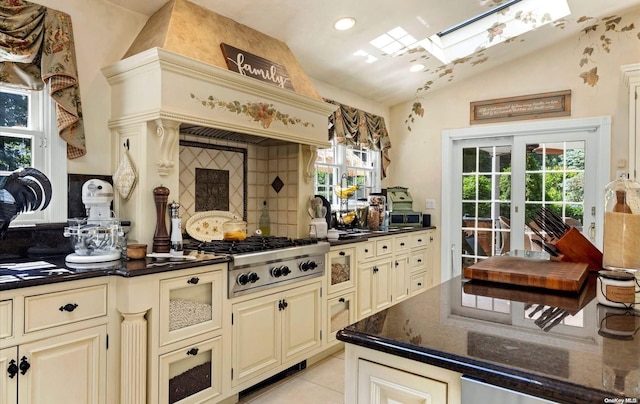 kitchen with cream cabinets, stainless steel gas cooktop, and plenty of natural light