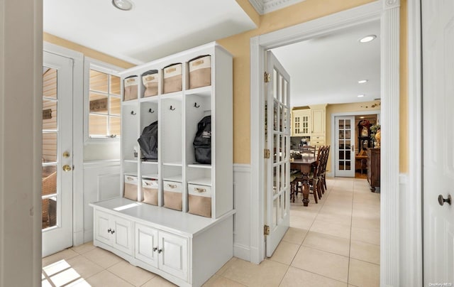 mudroom featuring french doors and light tile patterned floors