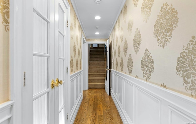 corridor featuring crown molding and hardwood / wood-style flooring