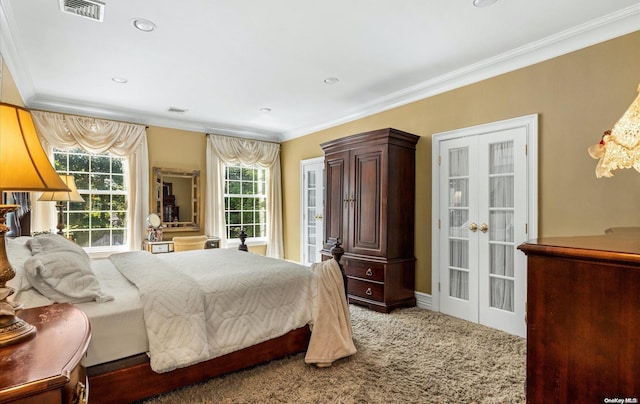 bedroom featuring carpet floors, crown molding, and french doors