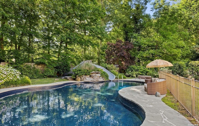 view of pool with a water slide