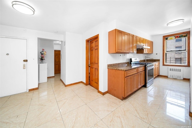 kitchen with gas stove, dark stone countertops, and radiator heating unit